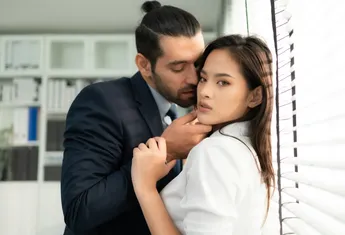 The executive is using his position of power to grope and touch the female employee's body