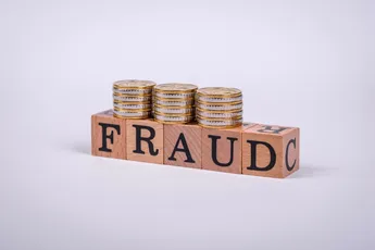 The inscription Fraud inspection made of wooden cubes on a plain background