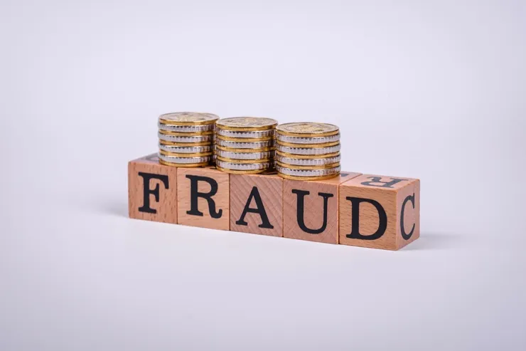 The inscription Fraud inspection made of wooden cubes on a plain background