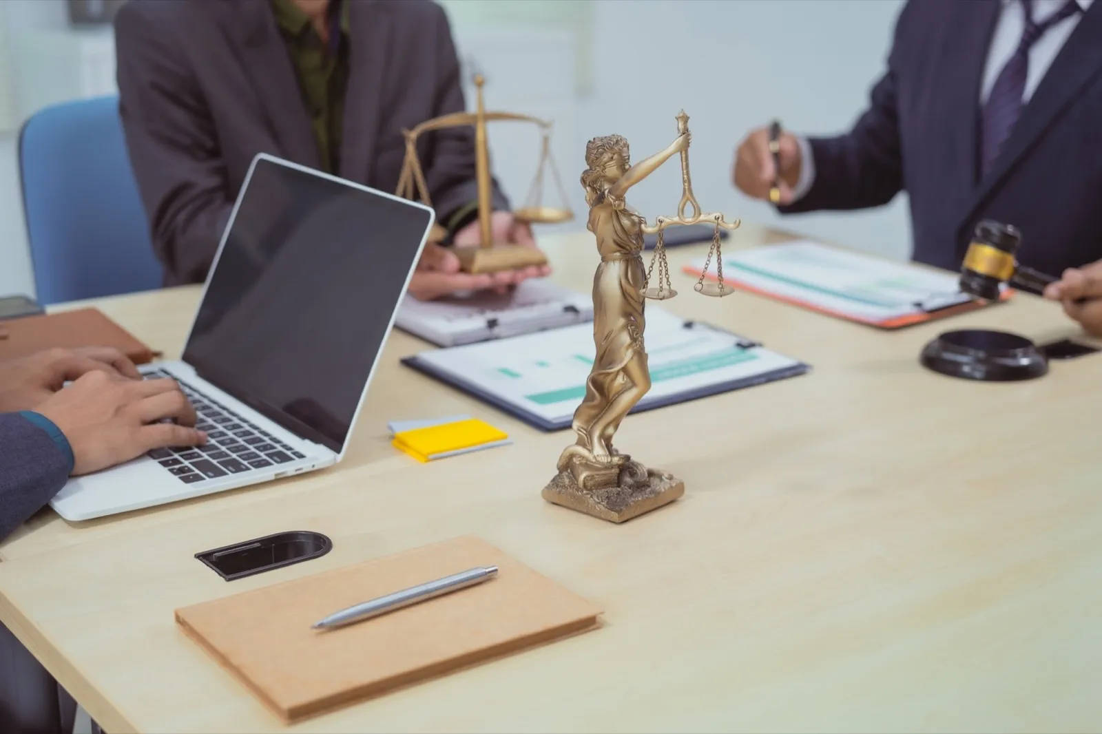 Three lawyers in a meeting at the table in an office, discussing business,civil and commercial law