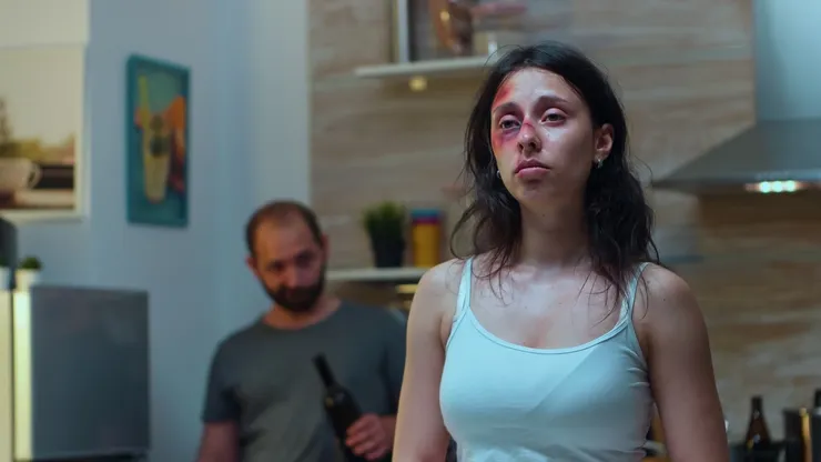 Traumatised woman looking at knife