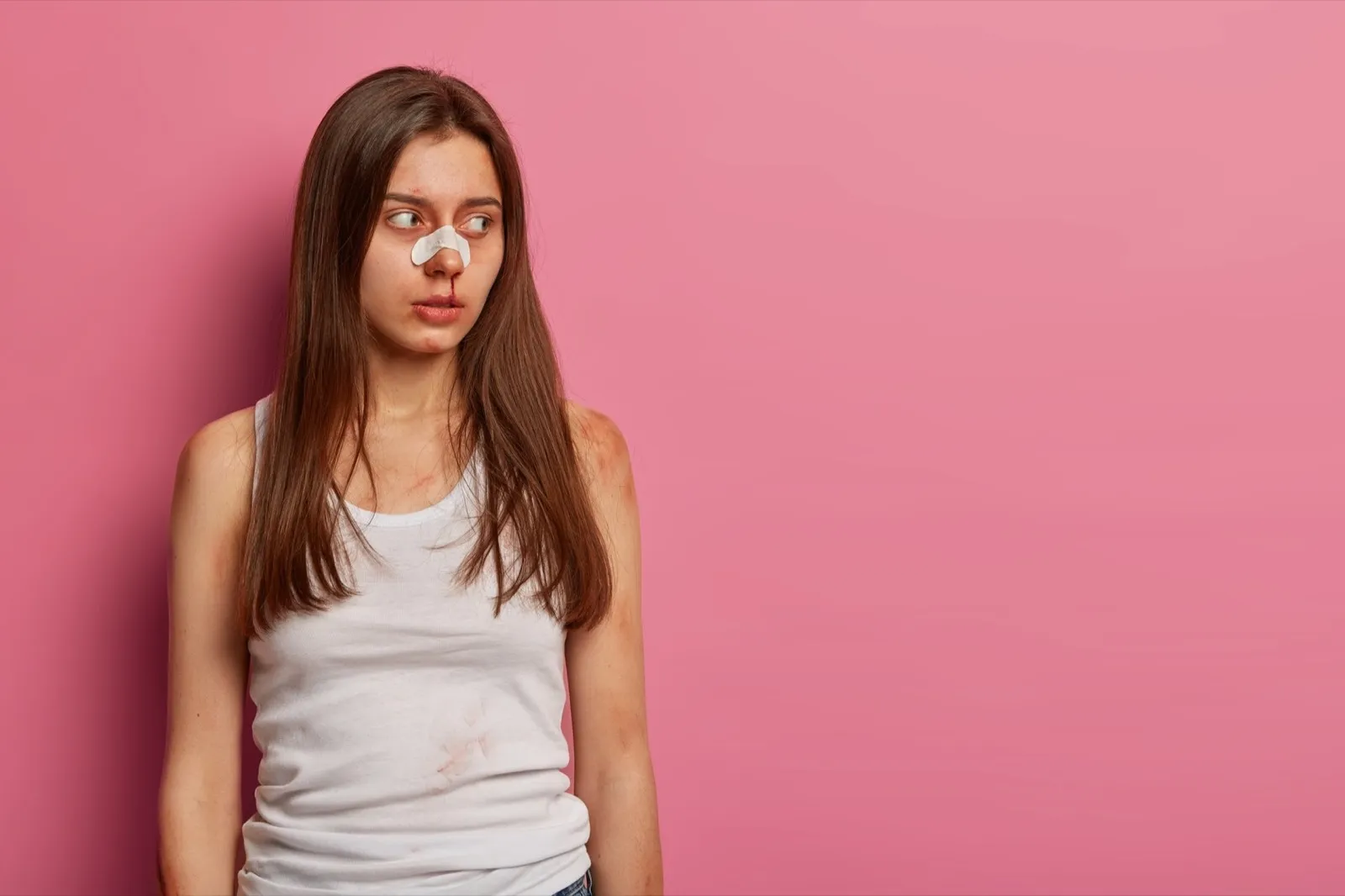 Unhappy girl being struck or beaten by cruel husband, looks sadly aside, becomes victim of sexual as