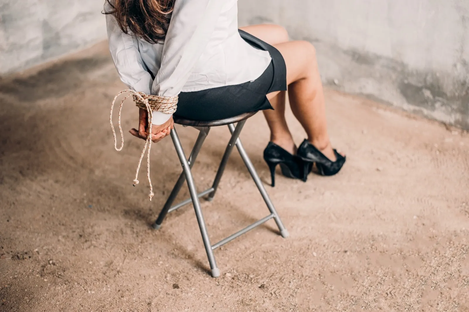 woman hands bound. Women were handcuffed and Sitting on a chair.woman tied hand to a chair. Crime