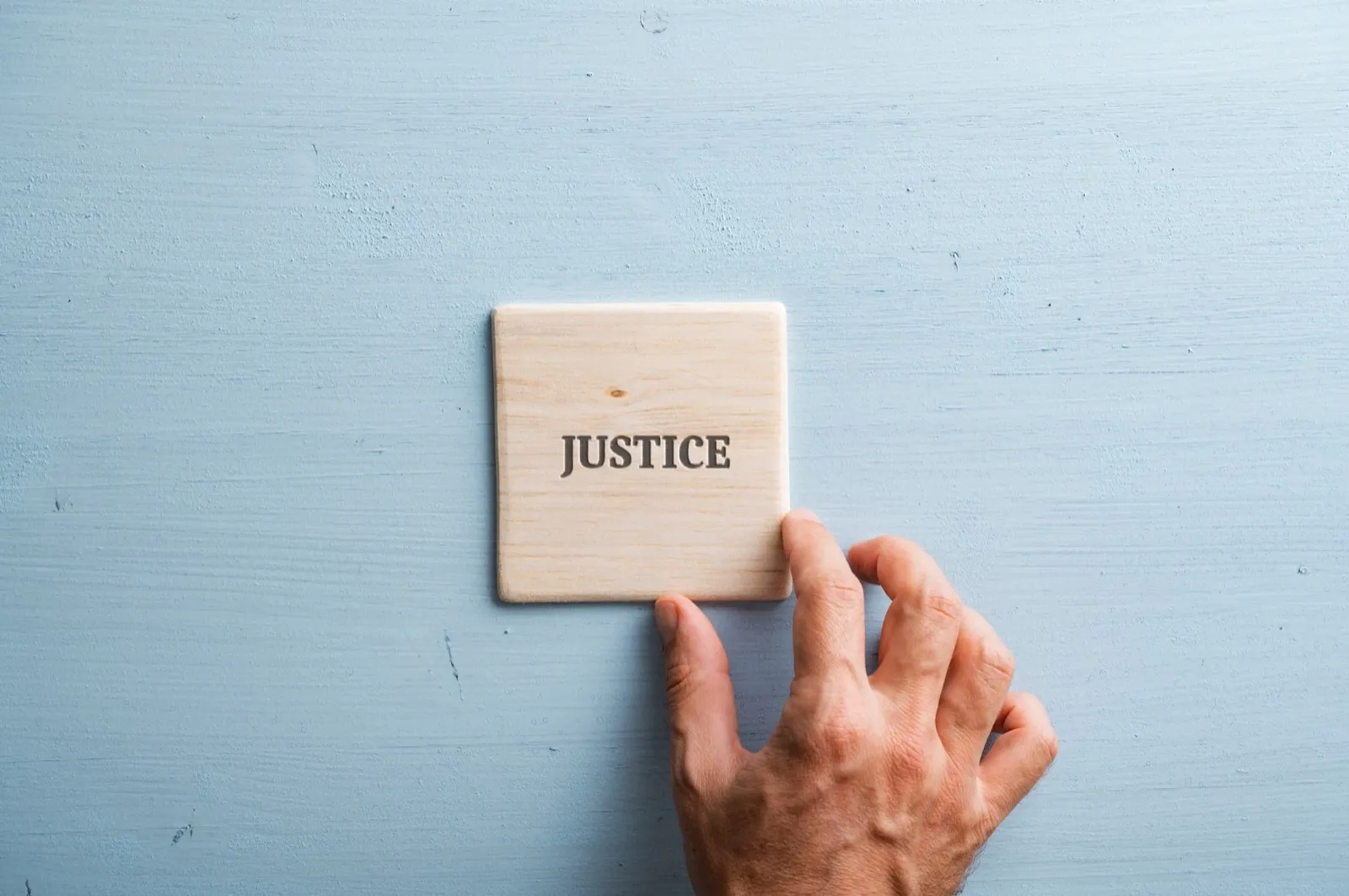 Word Justice printed on wooden tile