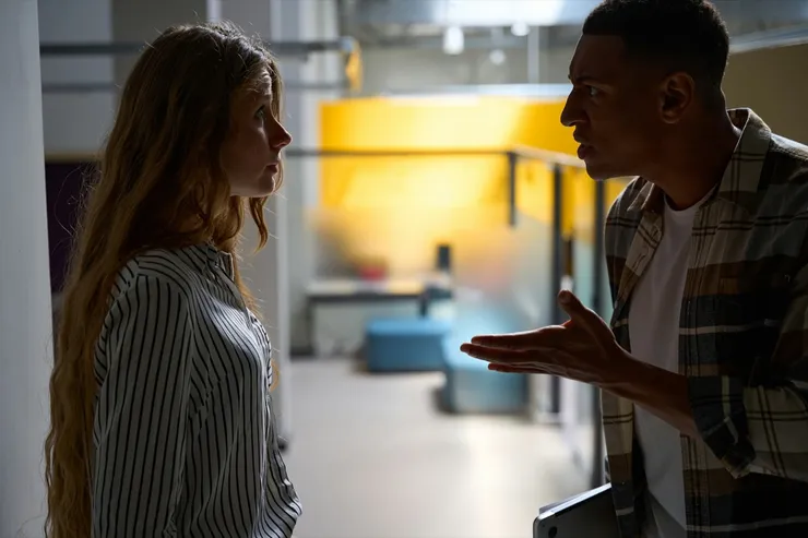 Young man and woman arguing in the office